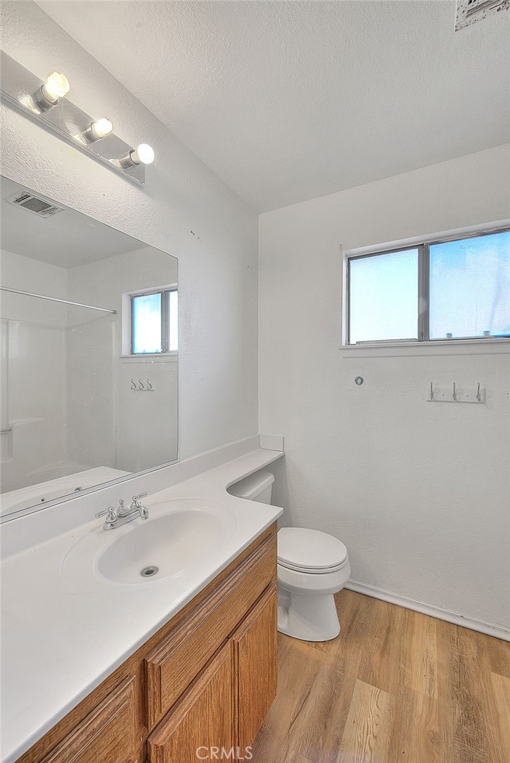 14811 Kingsdale Road Apple Valley, CA 92307 - Photo 29 of 57 a bathroom with a sink a toilet and a mirror