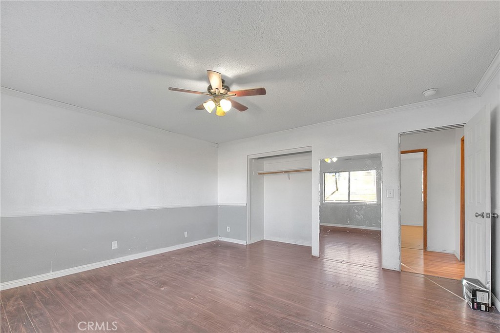 14811 Kingsdale Road Apple Valley, CA 92307 - Photo 30 of 57 a view of an empty room with wooden floor and window
