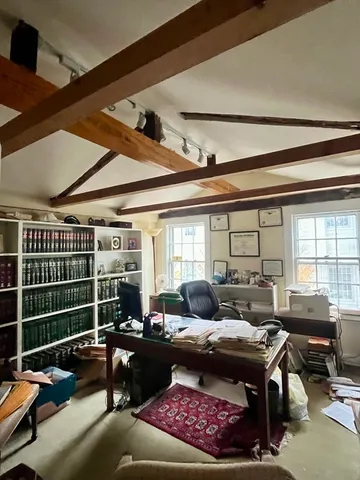 a living room with furniture a rug and a window