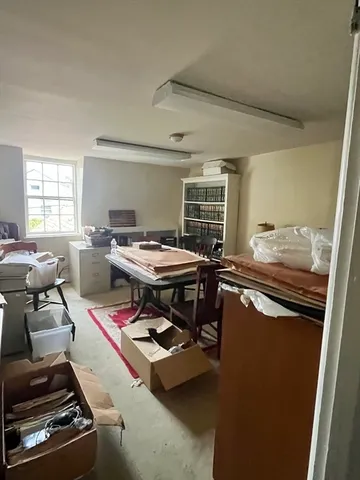 a room with furniture pool table and windows