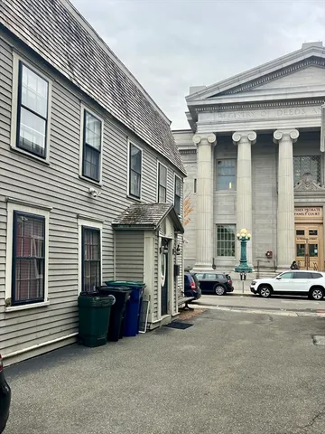 a couple of cars parked in front of a house