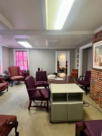 a living room with furniture a rug and a window