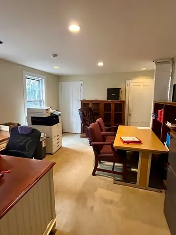 a living room with furniture a table and kitchen view
