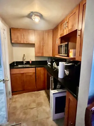 a kitchen with a sink and a stove top oven