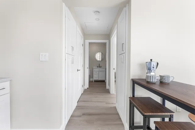 a view of a hallway to a livingroom and a hallway