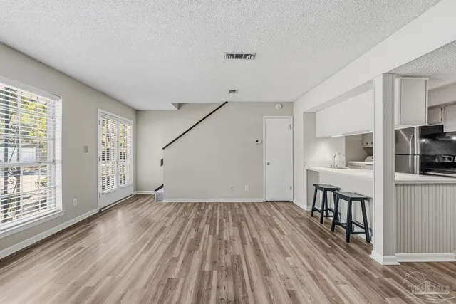a view of kitchen with furniture and wooden floor