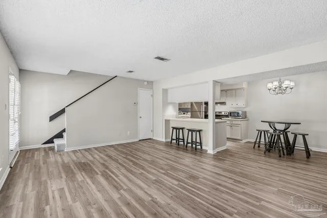 a view of kitchen with granite countertop cabinets table and chairs