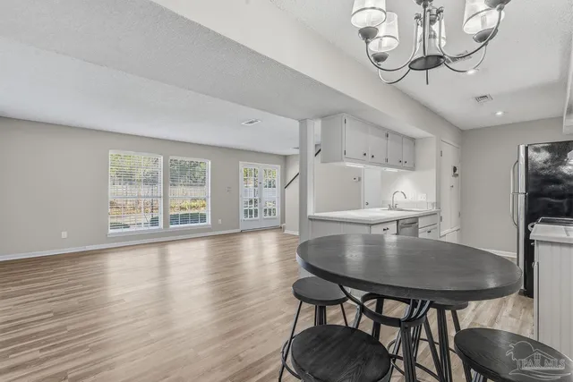a kitchen with stainless steel appliances a sink and a refrigerator