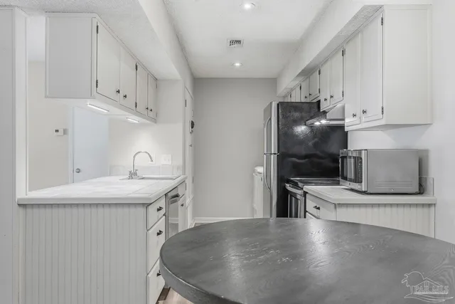 a kitchen with stainless steel appliances granite countertop a sink and a stove