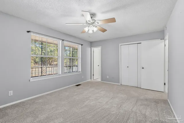 a bathroom with a granite countertop toilet and a sink