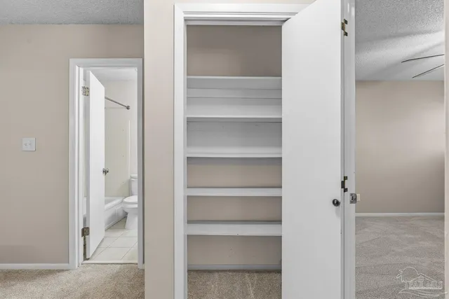 a bathroom with a toilet a sink and a mirror