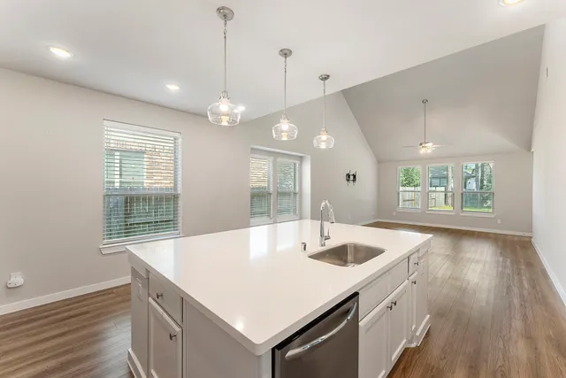 a kitchen with a sink center island with wooden floor