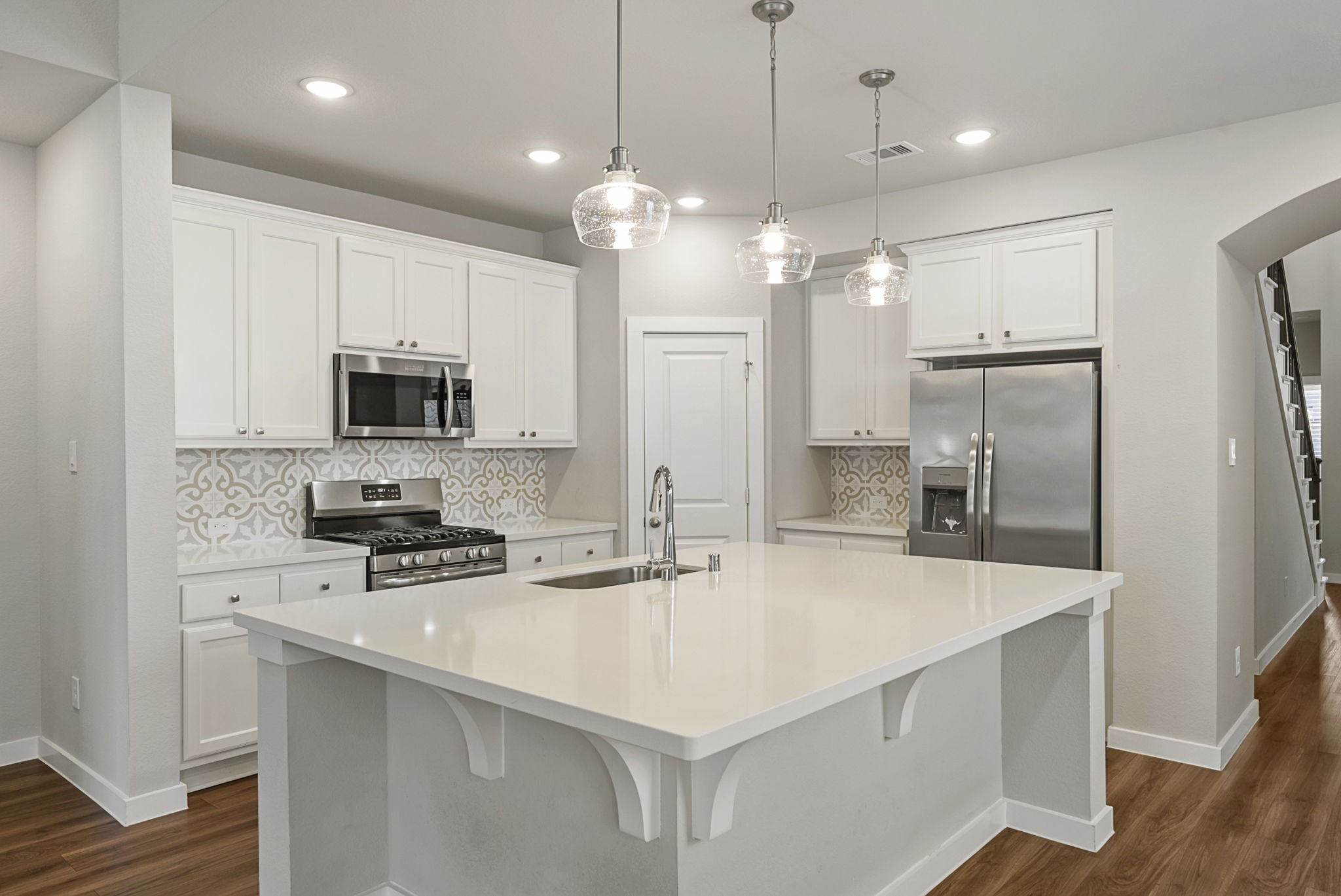421 Soapberry Tree Court Conroe, TX 77318 - Photo 15 of 50 a kitchen with stainless steel appliances a stove a sink and a refrigerator
