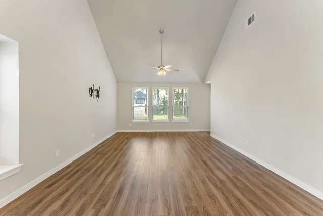 wooden floor in an empty room with a window