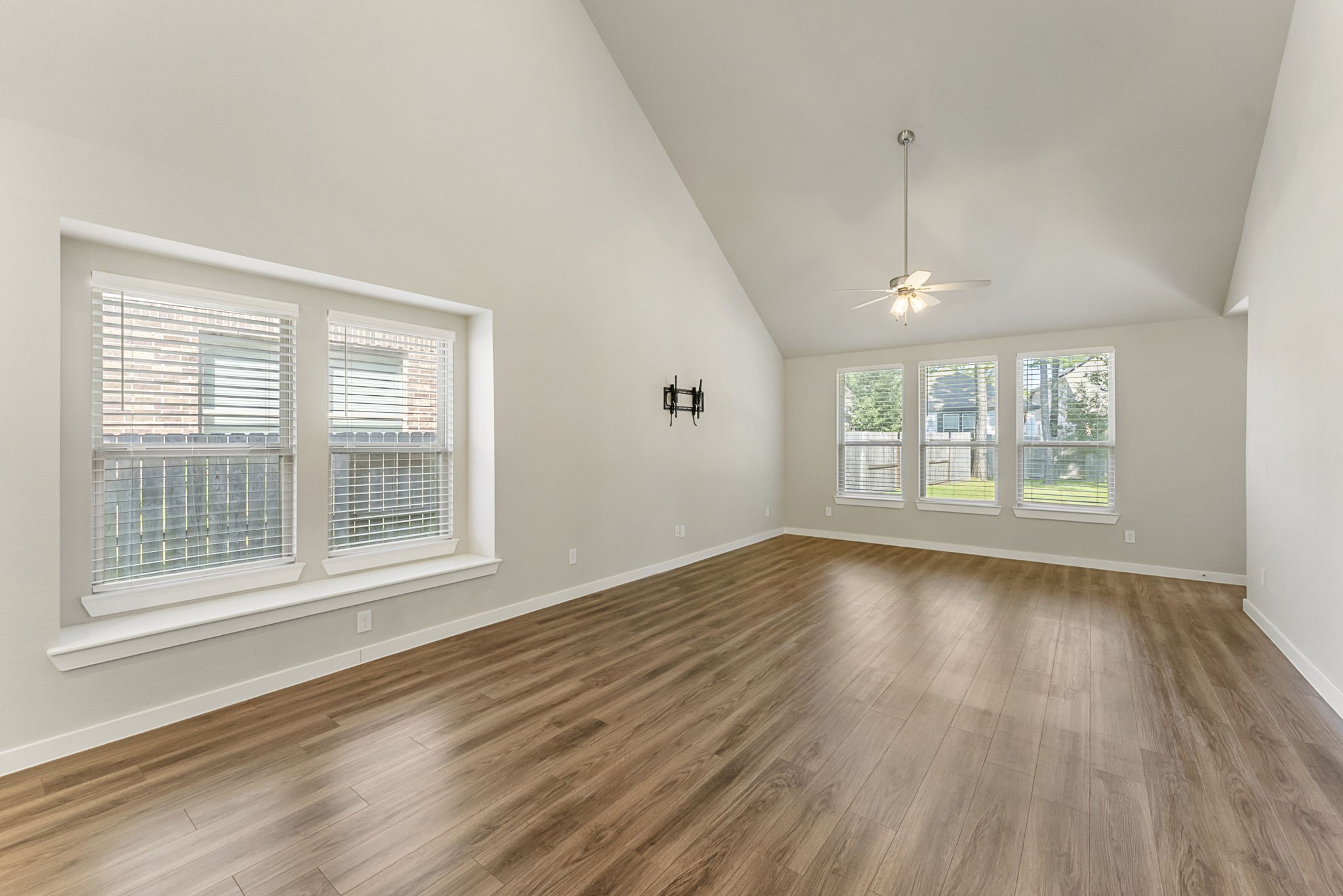 421 Soapberry Tree Court Conroe, TX 77318 - Photo 18 of 50 a view of an empty room with wooden floor and a window