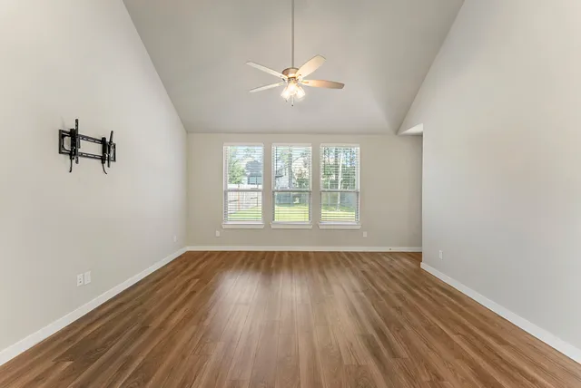wooden floor in an empty room with a window
