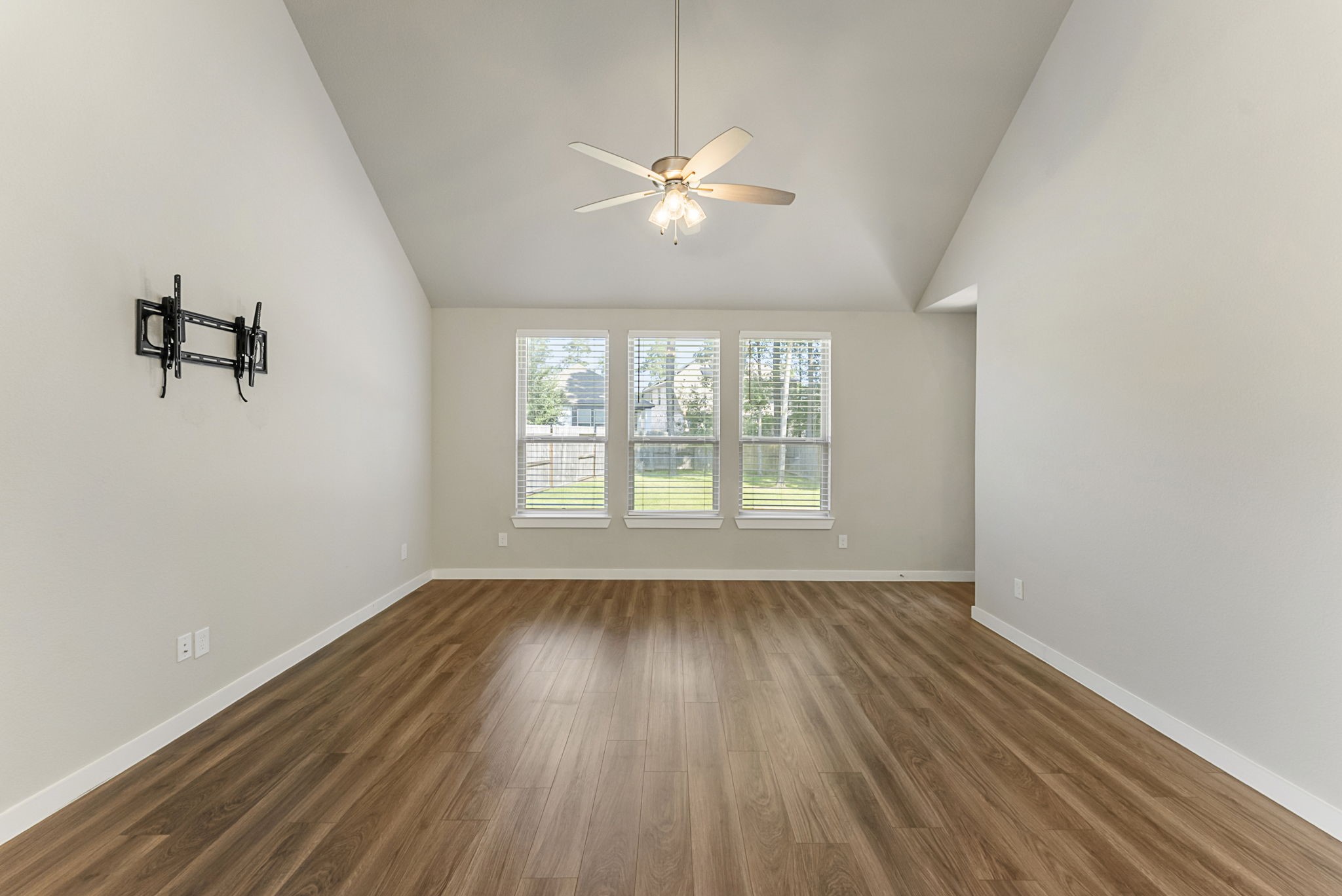 421 Soapberry Tree Court Conroe, TX 77318 - Photo 20 of 50 wooden floor in an empty room with a window