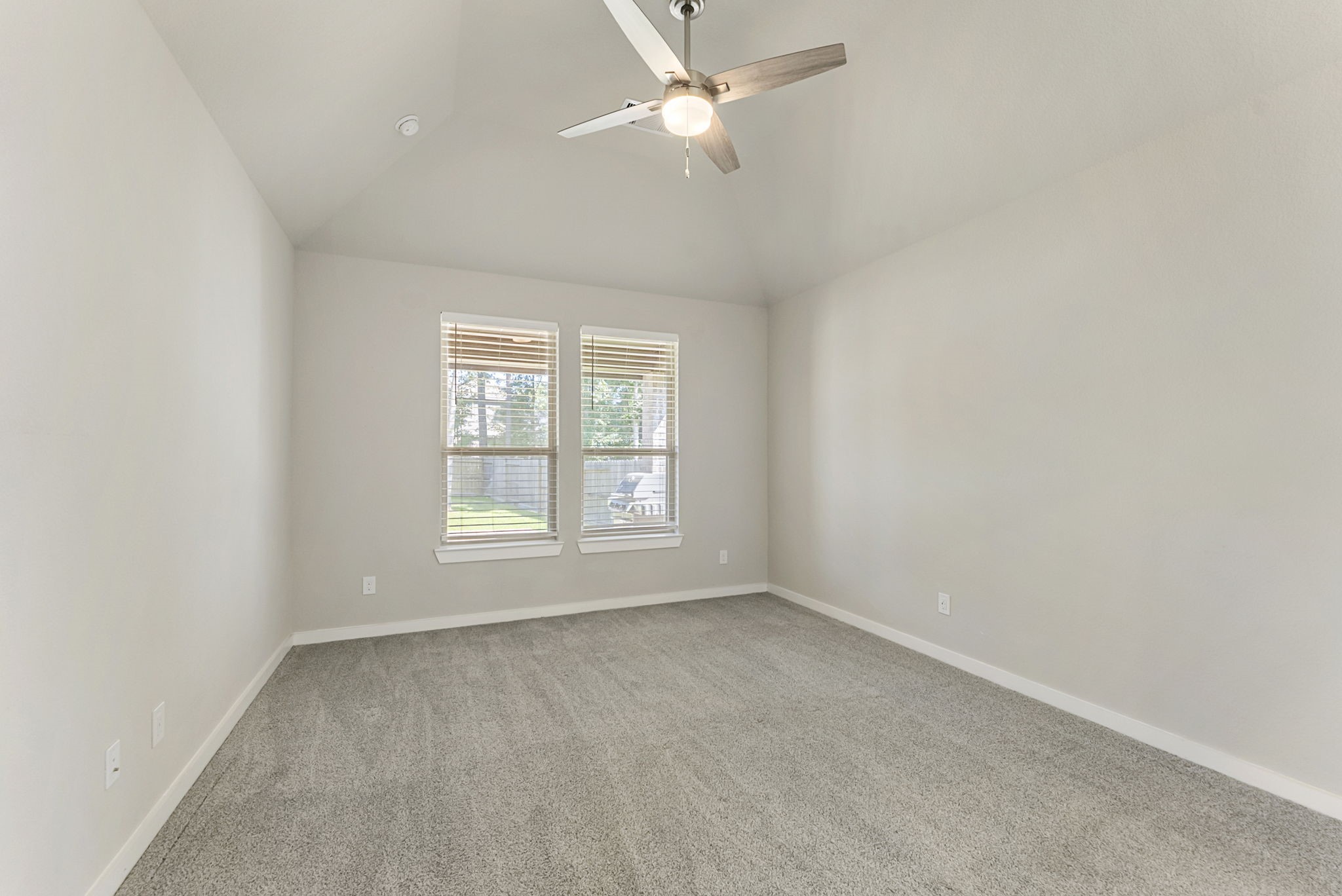 421 Soapberry Tree Court Conroe, TX 77318 - Photo 21 of 50 an empty room with a window and a fan