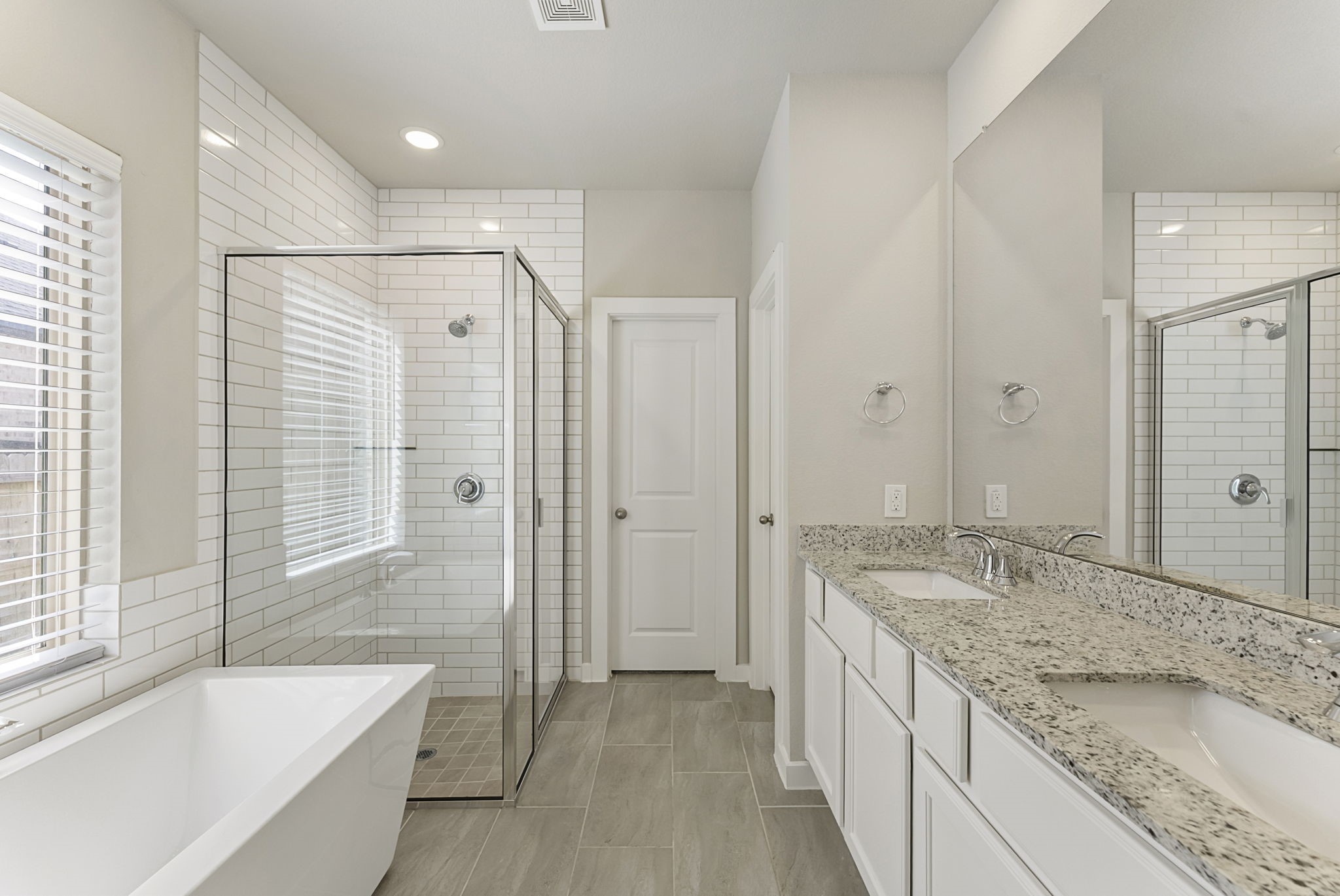 421 Soapberry Tree Court Conroe, TX 77318 - Photo 23 of 50 a bathroom with a granite countertop tub sink and mirror