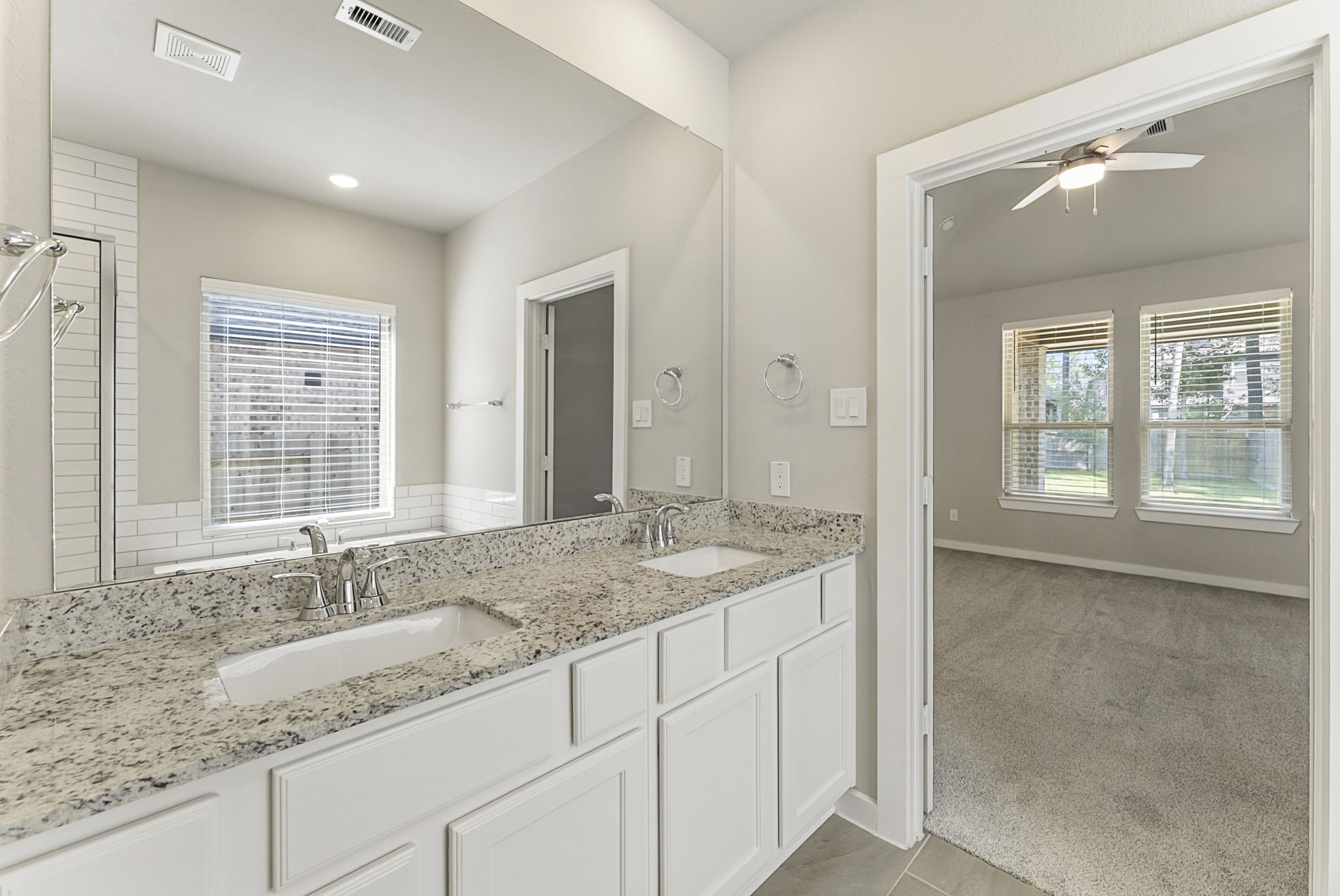 421 Soapberry Tree Court Conroe, TX 77318 - Photo 25 of 50 a bathroom with a granite countertop sink and mirror with window