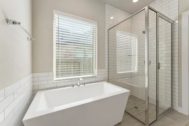 a bathroom with a glass shower door and a sink