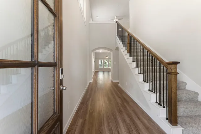a view of entryway and gallery with wooden floor