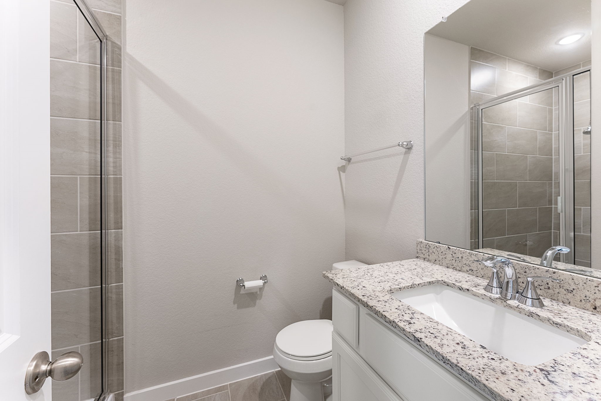 421 Soapberry Tree Court Conroe, TX 77318 - Photo 30 of 50 a bathroom with a granite countertop sink a toilet and a mirror