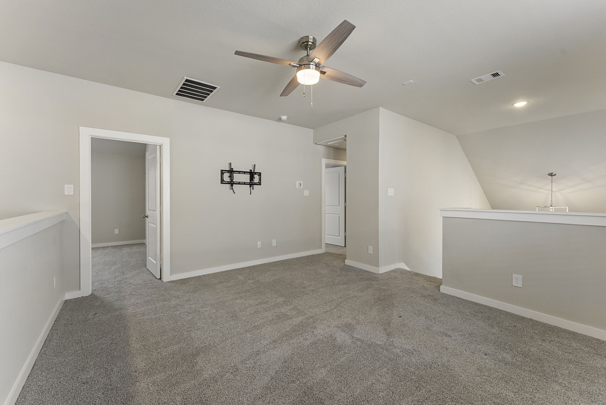 421 Soapberry Tree Court Conroe, TX 77318 - Photo 33 of 50 a view of an empty room with a ceiling fan