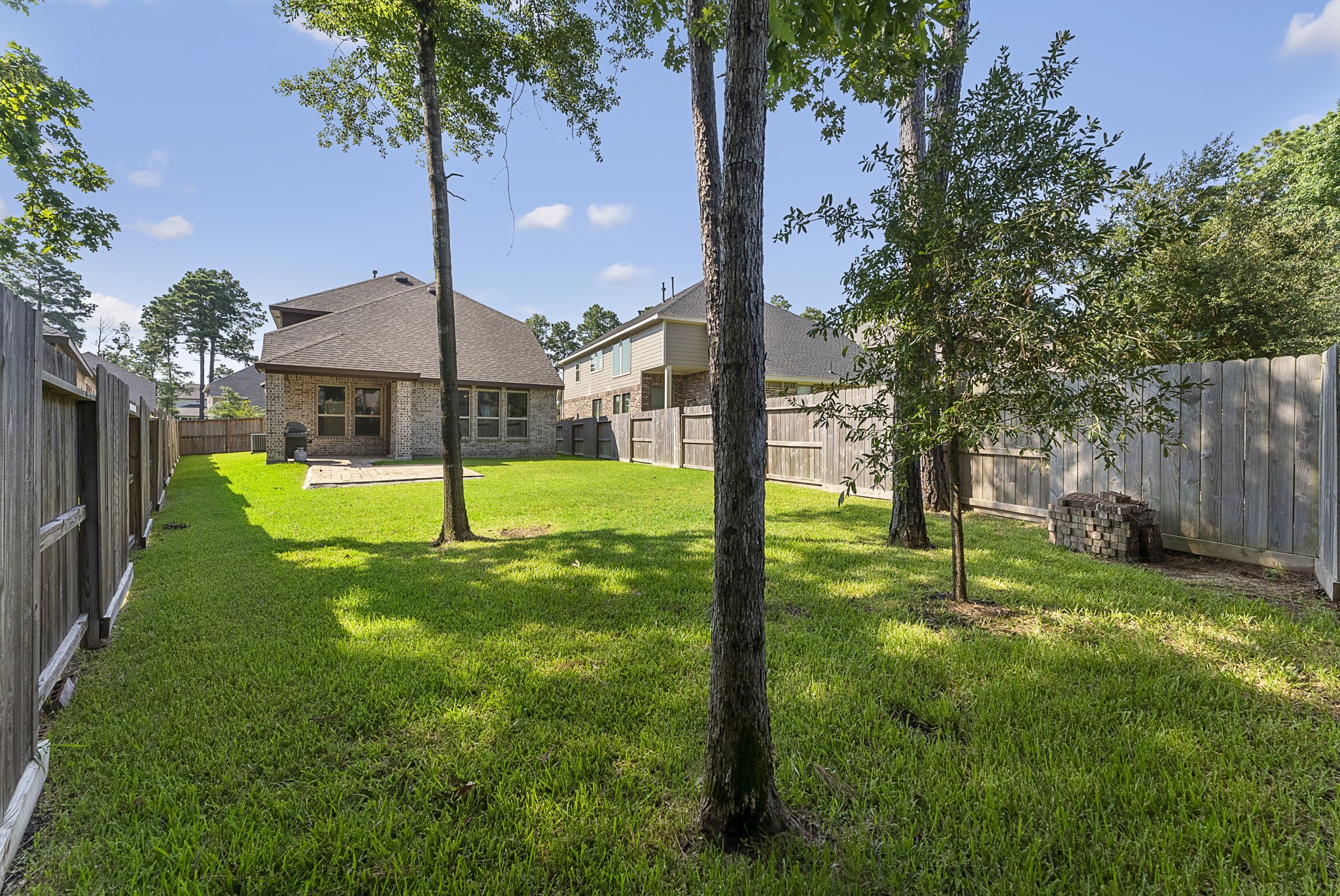 421 Soapberry Tree Court Conroe, TX 77318 - Photo 43 of 50 a view of a house with a yard and palm tree