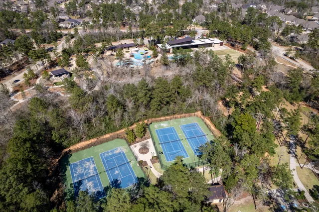an aerial view of a house with a yard and lake view