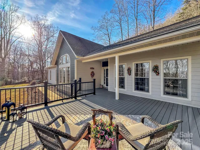a view of a roof deck with wooden floor and fence