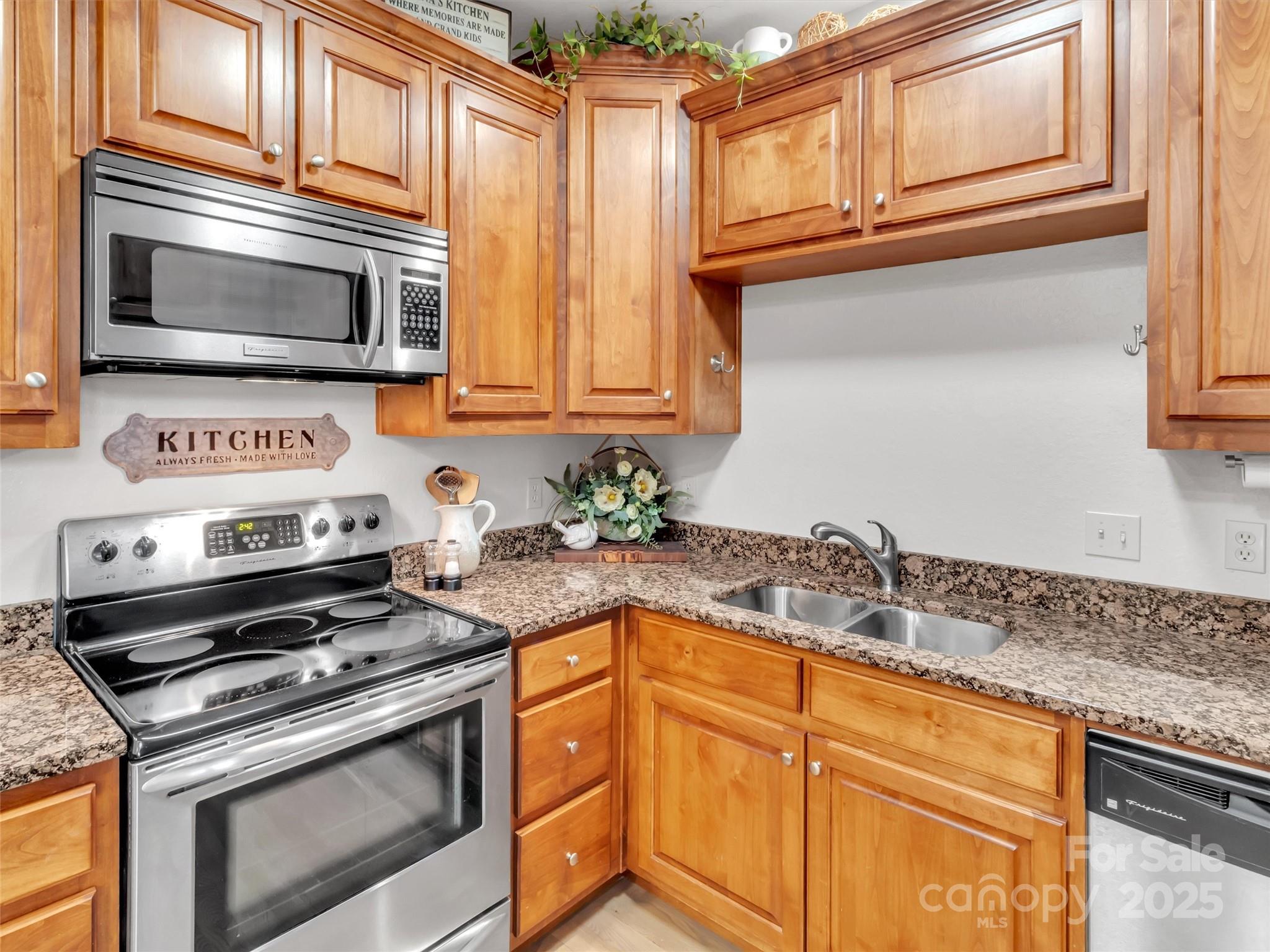 166 Amaroo Ridge, Unit 5 6 Sylva, NC 28779 - Photo 25 of 48 a kitchen with granite countertop cabinets stainless steel appliances and a sink