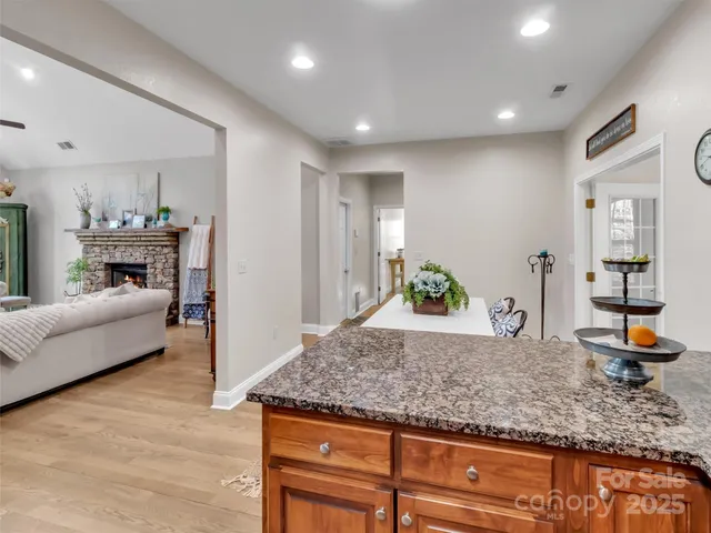 a living room with kitchen island furniture and a wooden floor