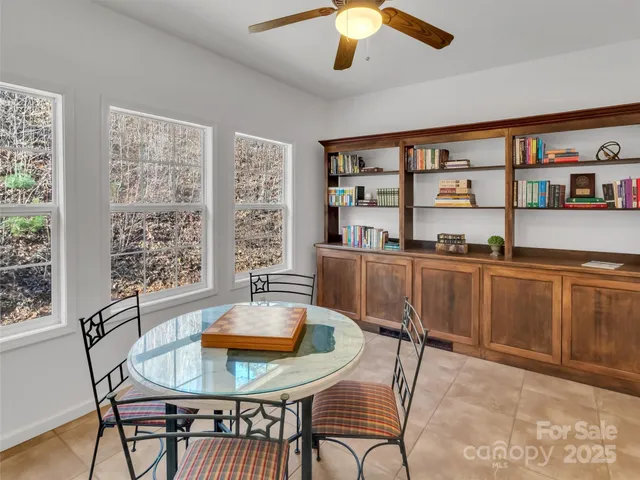 a dining room with furniture and a floor to ceiling window