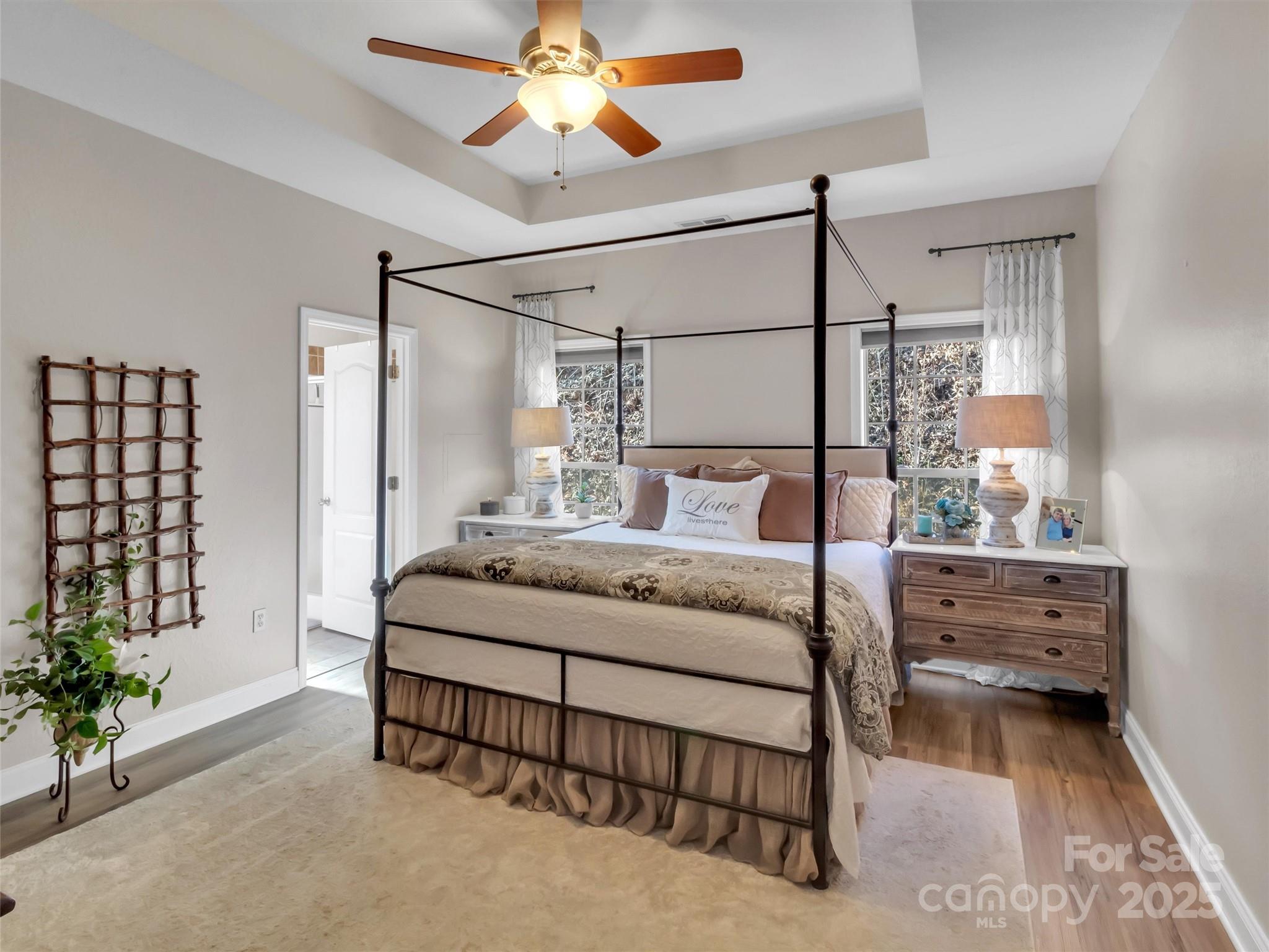 166 Amaroo Ridge, Unit 5 6 Sylva, NC 28779 - Photo 32 of 48 a bedroom with a bed and a chandelier