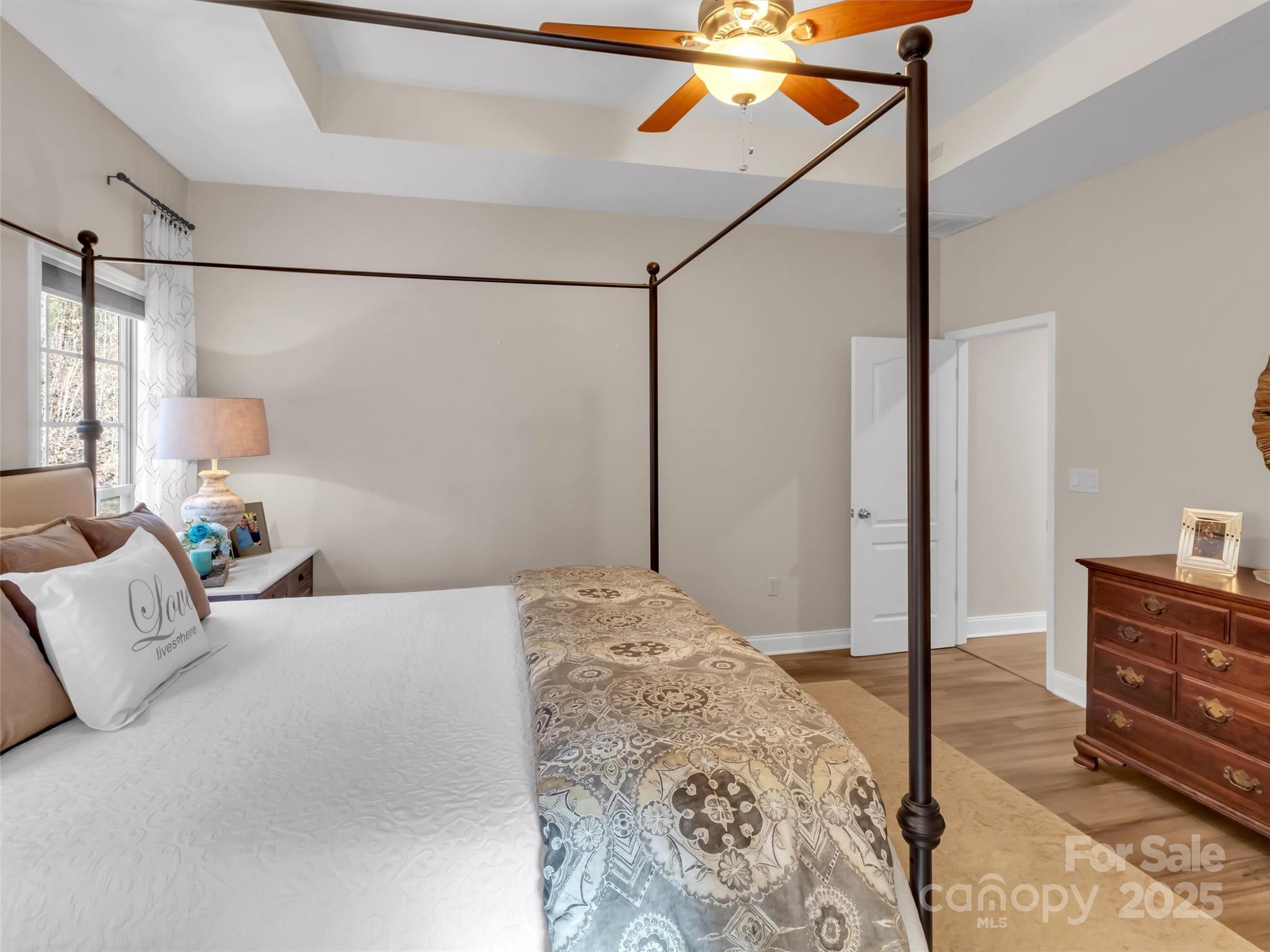 166 Amaroo Ridge, Unit 5 6 Sylva, NC 28779 - Photo 33 of 48 a bedroom with a bed and wooden floor