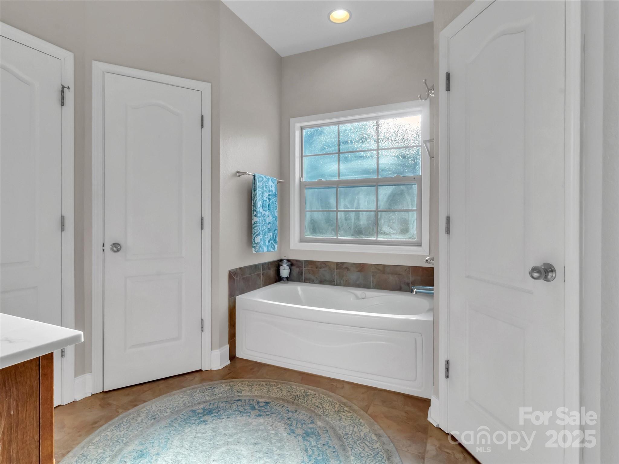 166 Amaroo Ridge, Unit 5 6 Sylva, NC 28779 - Photo 34 of 48 a bathroom with a bathtub and a window