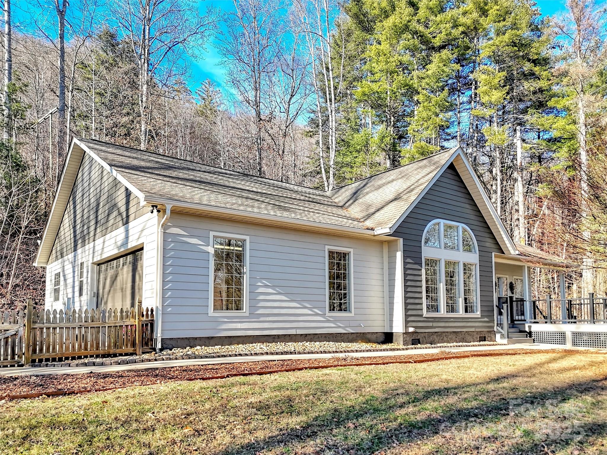 166 Amaroo Ridge, Unit 5 6 Sylva, NC 28779 - Photo 46 of 48 a front view of a house with a yard and garage