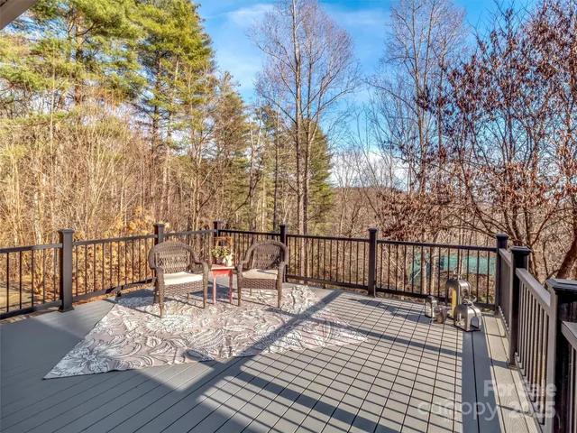 a balcony with chairs and wooden fence