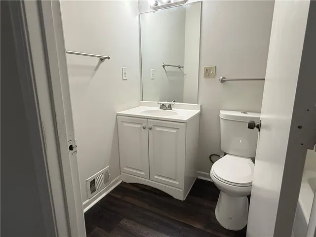 a white toilet sitting next to a bath tub