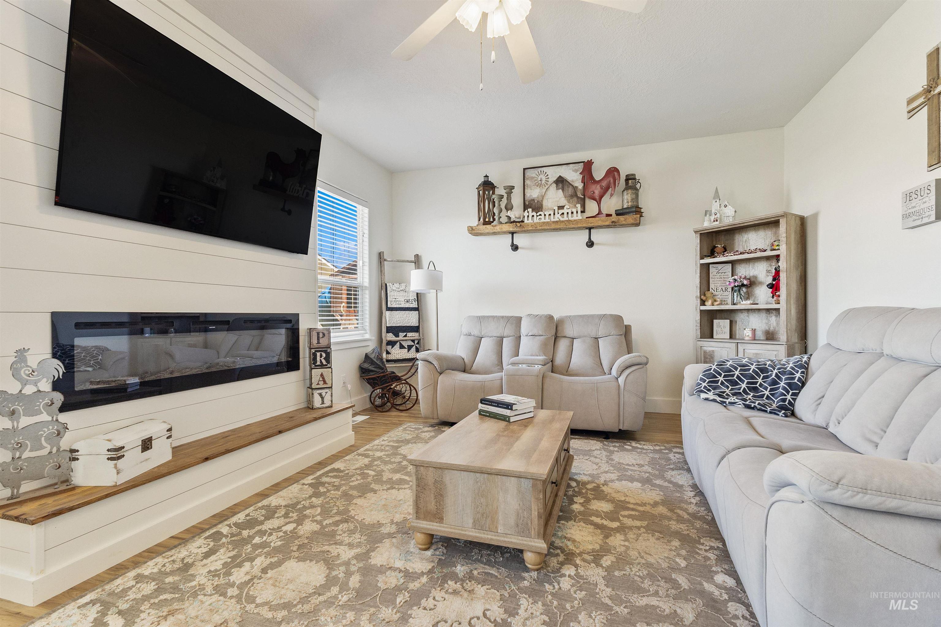 19876 Scotts Lane Caldwell, ID 83607 - Photo 27 of 44 Living room with a shiplap feature wall and built-in linear fireplace