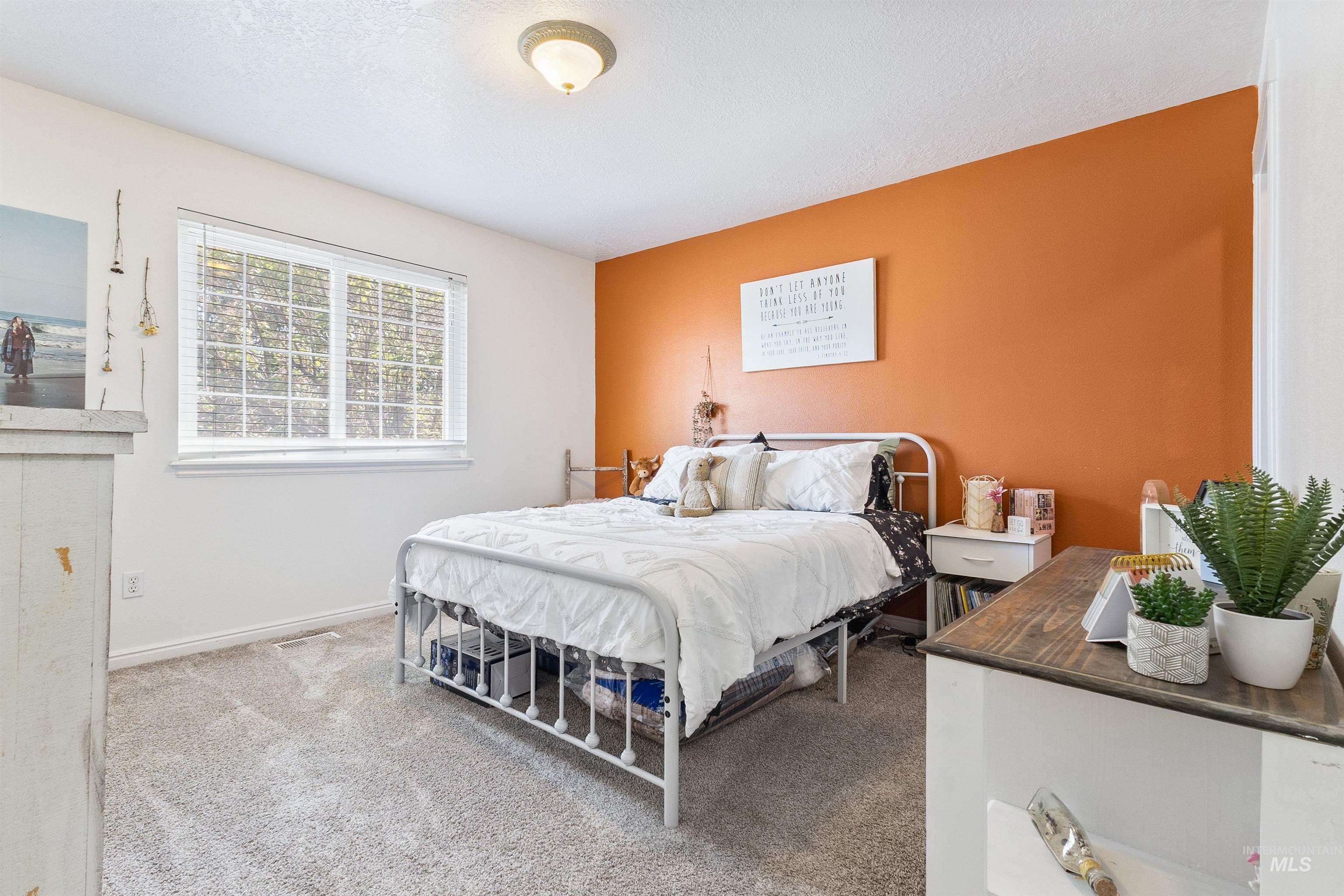 19876 Scotts Lane Caldwell, ID 83607 - Photo 44 of 44 Wall-to-wall carpeting in a neutral tone complements the white walls and single accent wall