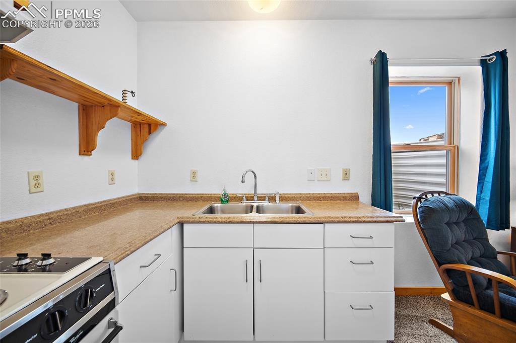 13475 South Hedi Road Sedalia, CO 80135 - Photo 12 of 28 a kitchen with a sink and cabinets