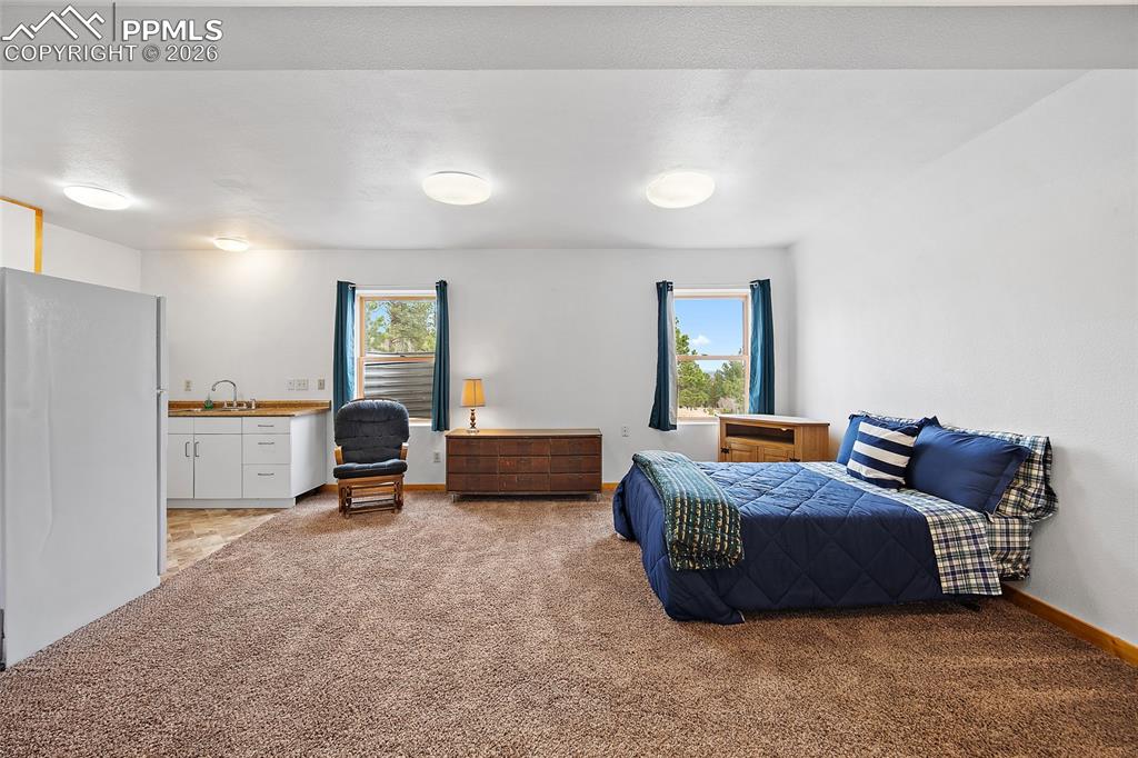 13475 South Hedi Road Sedalia, CO 80135 - Photo 14 of 28 a bedroom with furniture and a window