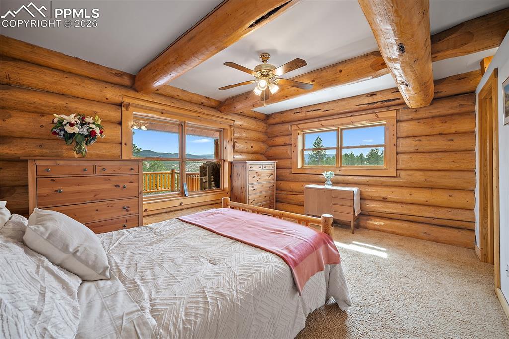 13475 South Hedi Road Sedalia, CO 80135 - Photo 15 of 28 a bed room with a bed and a chandelier