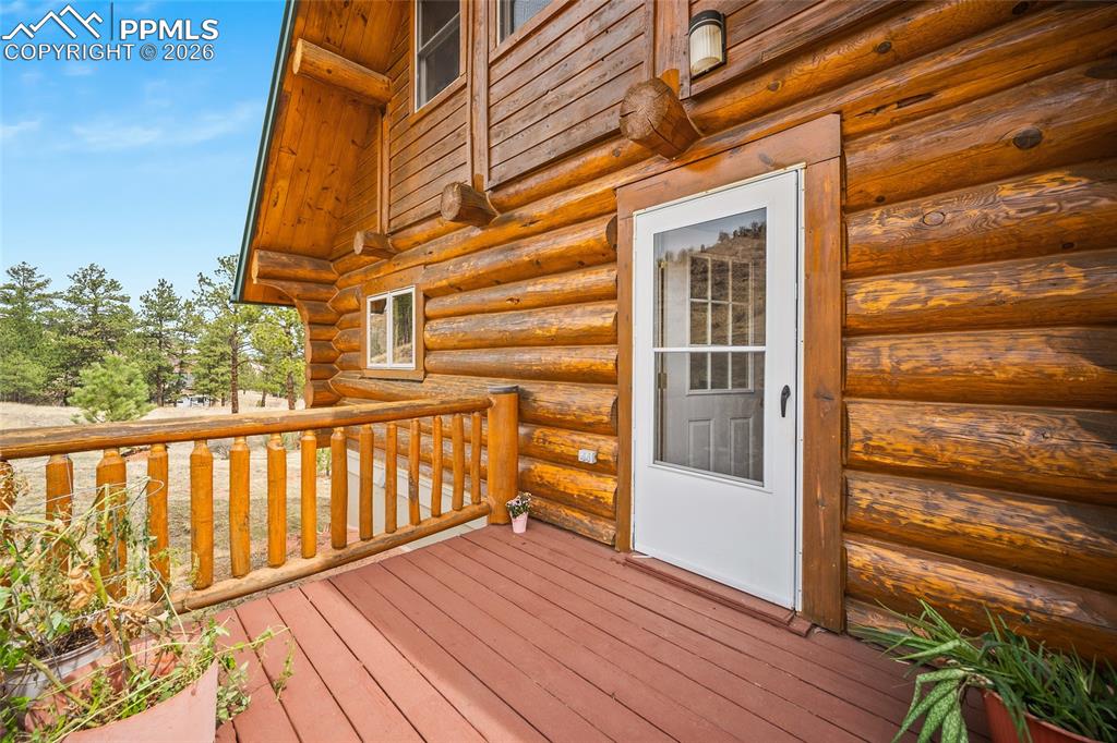 13475 South Hedi Road Sedalia, CO 80135 - Photo 24 of 28 a view of a balcony with wooden floor and fence