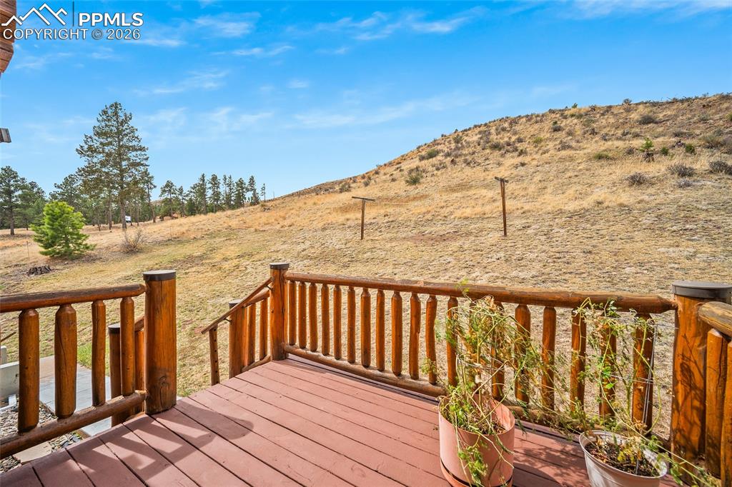 13475 South Hedi Road Sedalia, CO 80135 - Photo 25 of 28 a terrace view with wooden floor and fence