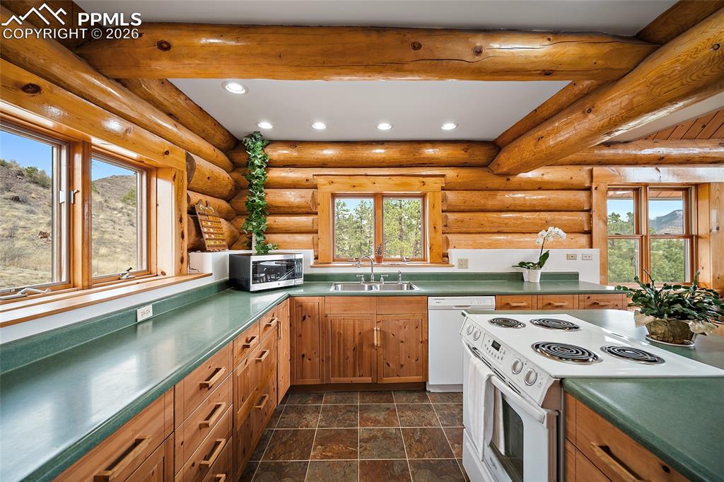 13475 South Hedi Road Sedalia, CO 80135 - Photo 6 of 28 a kitchen with a sink stove and cabinets
