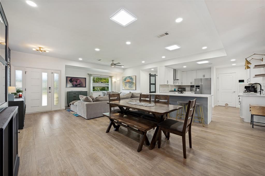 3619 Merrell Road Dallas, TX 75229 - Photo 7 of 26 Open-concept living space featuring wood-finish flooring, recessed lighting, and a skylight