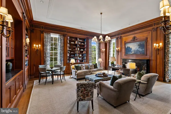a dining room with furniture a chandelier and wooden floor
